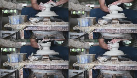 一名亚洲华人在他的作坊里用纺车制作陶器高清在线视频素材下载