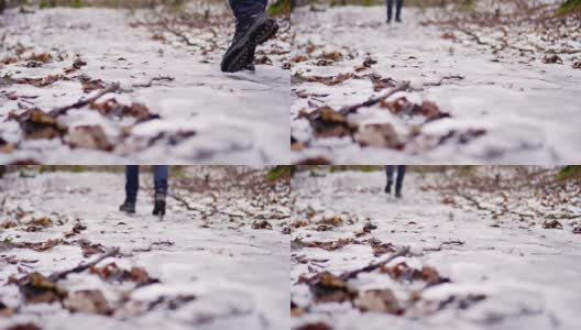 穿冬靴的腿穿过厚厚的积雪。近距离观察鞋子。在雪滩上行走，在冬天徒步旅行。高清在线视频素材下载