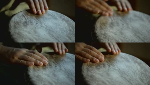 一个男人的手在一个非洲皮肤覆盖的手鼓上敲出一个节拍。高清在线视频素材下载
