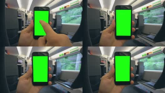 在火车上拿着绿色屏幕的手机高清在线视频素材下载