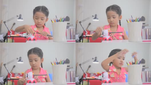 亚洲小女孩用彩色卷笔刀高清在线视频素材下载