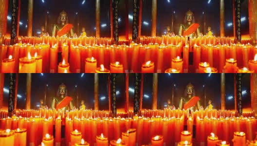 多莉，寺庙里有带蜡烛的佛像高清在线视频素材下载