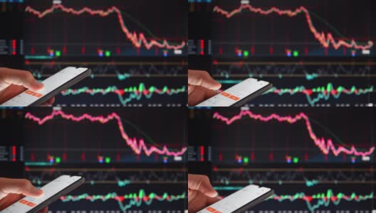 在证券交易所的大屏幕前用智能手机查看股票价格的人。有智能手机的人在屏幕前看着股价下跌。高清在线视频素材下载