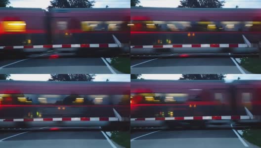 在奥地利一个封闭的铁路道口，透过挡风玻璃看到一辆汽车和一辆正在行驶的客运列车高清在线视频素材下载