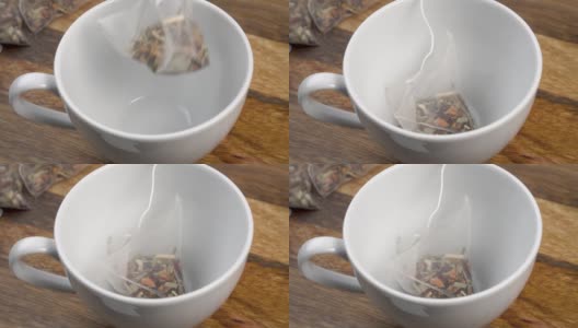 空白茶杯与花草芳香茶包旧板高清在线视频素材下载