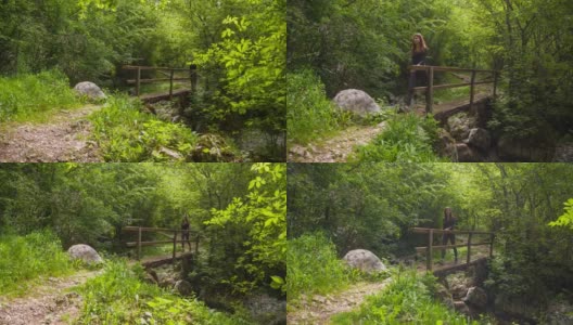 一位年轻的女子正穿过山间小溪上的一座小木桥高清在线视频素材下载