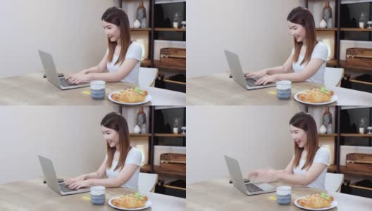 漂亮的女人在家里用笔记本电脑工作，亚洲女商人在家里通过视频在线会议。高清在线视频素材下载