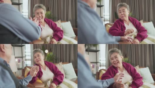 幸福亚洲成年退休女性休闲服饰放松坐在沙发沙发上与家人聊天交谈假期周末客厅，亚洲老年女性与家人良好的关系留在家里呆在家里高清在线视频素材下载