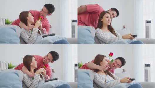 亚洲青年惊喜送玫瑰给美丽的女友。迷人浪漫的新婚男女花时间在房子里一起庆祝周年纪念日和情人节。高清在线视频素材下载