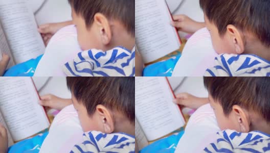 亚洲男孩在床上看书高清在线视频素材下载