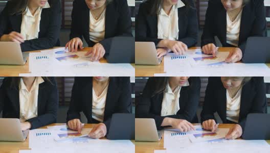 两位商务女性在非正式的办公室会议上使用笔记本电脑高清在线视频素材下载