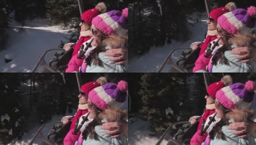 母亲和女儿在寒假里享受滑雪缆车高清在线视频素材下载
