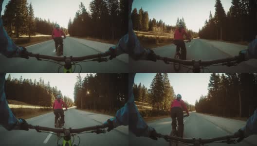 一对夫妇在乡村公路上骑自行车高清在线视频素材下载