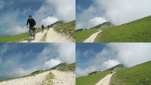 HD CRANE:骑在山间小道上的自行车手高清在线视频素材下载
