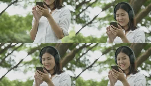 亚洲年轻女性听音乐与无线耳机在秋季公园-播客高清在线视频素材下载