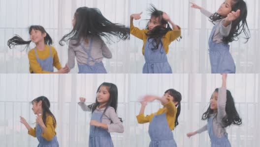 两个年轻的亚洲女孩在家里一起跳舞。高清在线视频素材下载