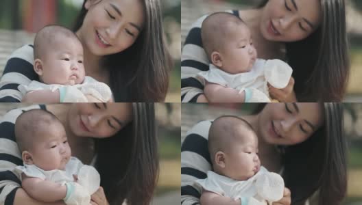亚裔中国母亲周末早上在公园里和孩子亲热高清在线视频素材下载