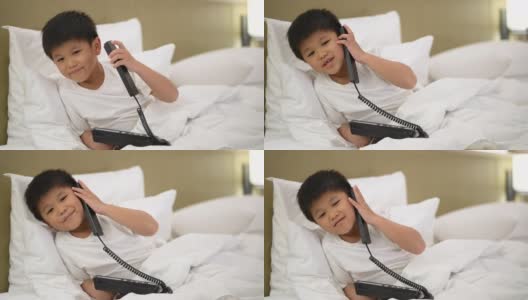 亚洲男孩打电话到酒店的接待处。接待和客户服务的理念高清在线视频素材下载