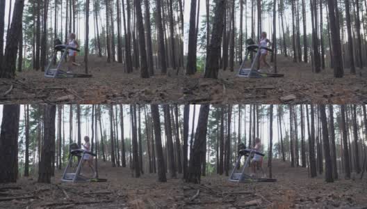 一名年轻女子在森林里的跑步机上跑步。多莉拍摄高清在线视频素材下载
