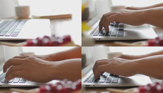 人类的双手在笔记本电脑键盘上打字，木桌上有在家工作的元素，多莉从右向左射击高清在线视频素材下载