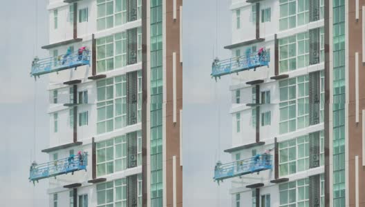 建筑工人在脚手架上粉刷大楼高清在线视频素材下载