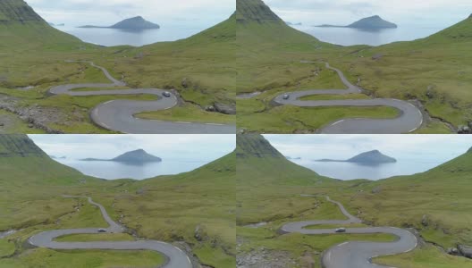 航拍:汽车沿着蜿蜒的乡间小路驶向法罗群岛海岸高清在线视频素材下载