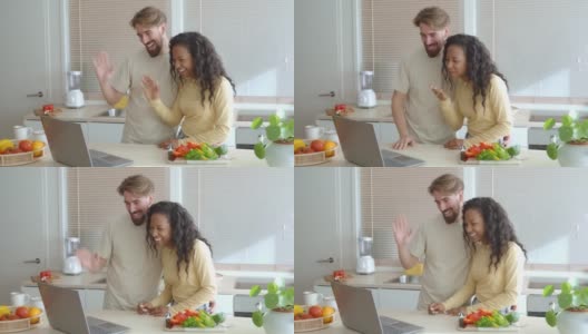年轻的异性恋多民族夫妇在厨房里视频通话高清在线视频素材下载