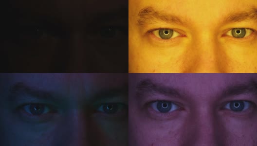 男性的特写眼睛被不同颜色的光照亮。高清在线视频素材下载