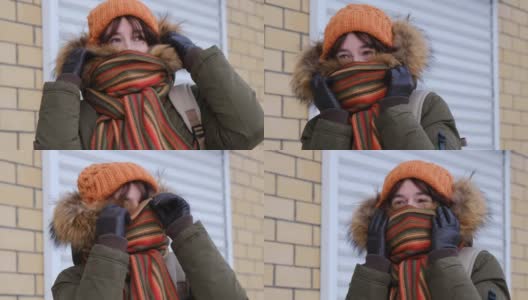 一个女人在冬日小镇的街道上等待着高清在线视频素材下载