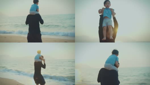 家庭旅游度假，父亲抱着儿子在海滩上放松。高清在线视频素材下载