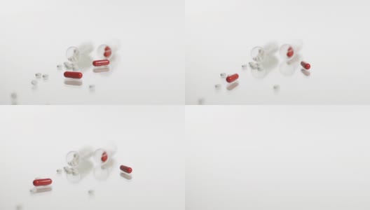 高清慢镜头:白色和红色药物下落高清在线视频素材下载