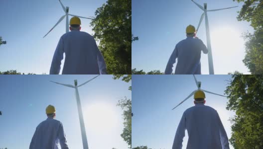 日落时分，一位年轻的工程师正在检查风车的正确操作和效率。理念:可再生能源、技术、电力、服务、绿色、未来高清在线视频素材下载