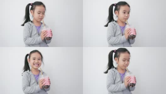 亚洲女孩用吸管喝饮料。高清在线视频素材下载