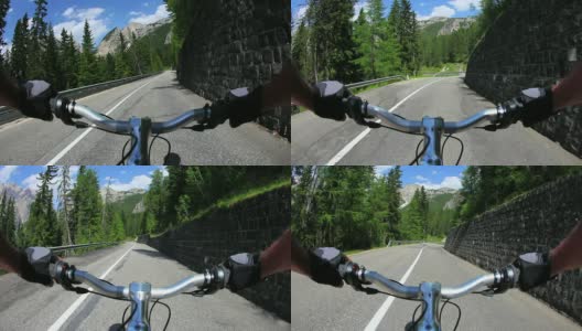 HD骑着自行车沿着一条高山路下山高清在线视频素材下载