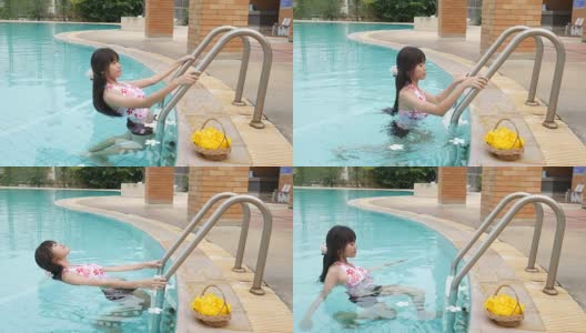 女人放松和享受在游泳池高清在线视频素材下载