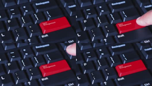 男性用手按下电脑键盘上的红色按钮，按钮上的文字是“数据管理”高清在线视频素材下载