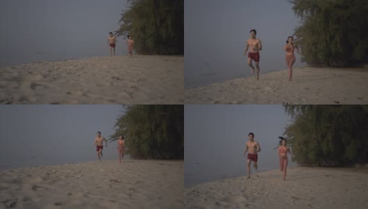 一对亚洲情侣在沙滩上慢跑。高清在线视频素材下载