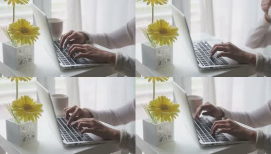 年轻女子使用笔记本电脑和喝咖啡高清在线视频素材下载
