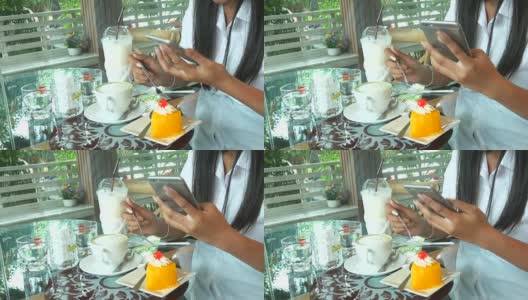 一个女人的手在咖啡店用智能手机高清在线视频素材下载