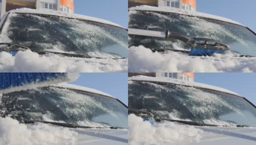 在一个阳光明媚的日子里，手动汽车刷从汽车引擎盖上扫雪高清在线视频素材下载