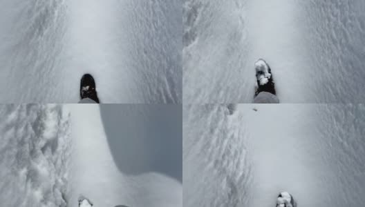 冬天穿登山靴的人走在雪地上，新雪上留下脚印。从眼睛看到的景色。冬季户外活动。新年,圣诞节。脚近距离。4 k高清在线视频素材下载