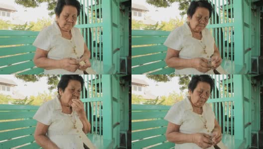 年长的亚洲女人在家吃土豆高清在线视频素材下载
