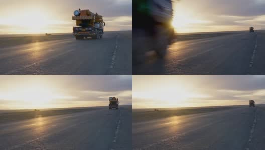 在金色的天空中，卡车行驶在乡村公路上高清在线视频素材下载