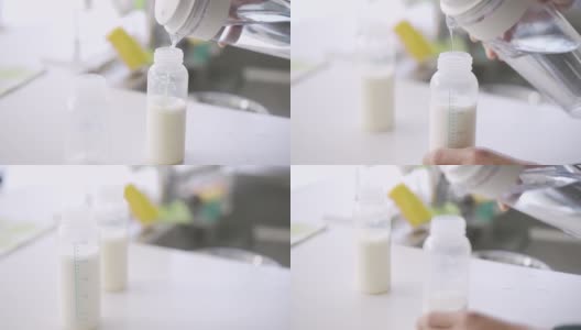 亚洲男人为双胞胎婴儿制作牛奶高清在线视频素材下载