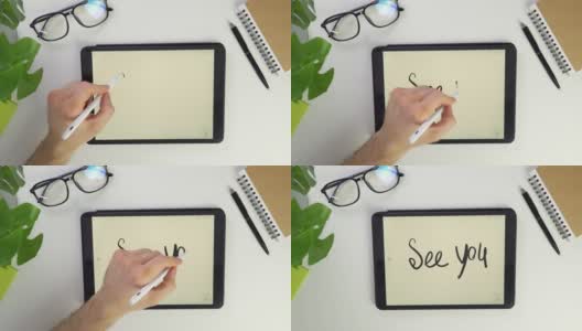 写看到你的手写笔在平板电脑屏幕上。用钢笔在屏幕上的触摸屏上绘制文本。俯视图的桌面在办公室在家里。记事本和笔。数字请注意。高清在线视频素材下载