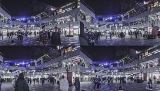 晚上，在中国北京三里屯购物广场，走在时尚年轻人中间高清在线视频素材下载