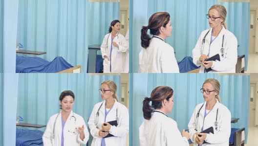 两个女医生在医院里讨论病例高清在线视频素材下载