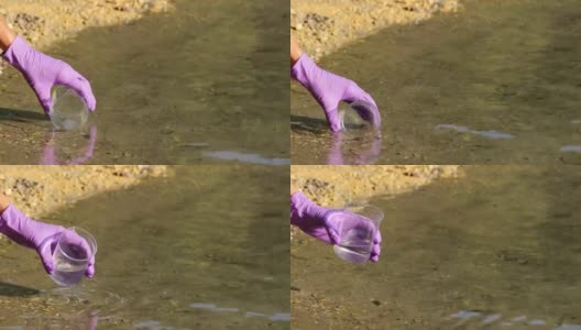 女科学家采集被污染的水样本高清在线视频素材下载