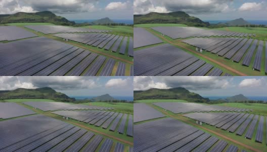 绿色田野的鸟瞰图，太阳能电池板用于可再生电力生产高清在线视频素材下载