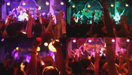 在夜总会的音乐会中，人们举起手臂跳舞高清在线视频素材下载
